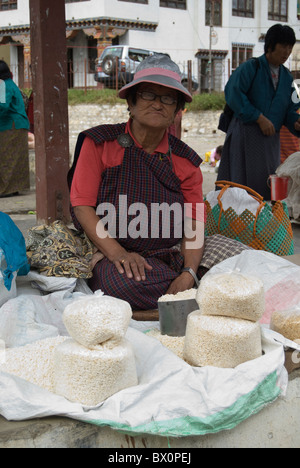 A woman selling rice in a fresh market in Paro town, Bhutan Stock Photo