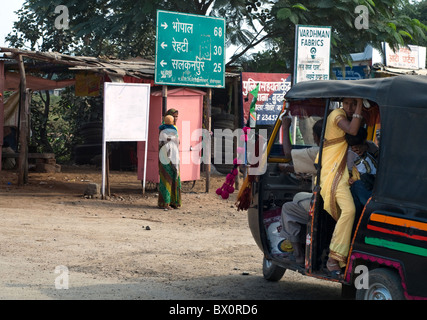 Traffic passing through a village in Madhya Pradesh, India Stock Photo
