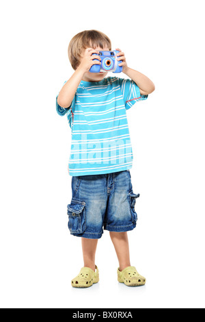 Full length portrait of a little boy taking pictures with a camera Stock Photo