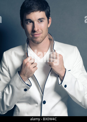 Fashion photo of a young smiling man wearing a white blazer Stock Photo