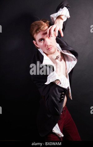 young man attacking with knife on black background Stock Photo