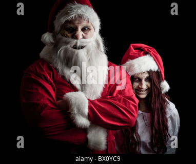 portrait of a scary looking santa claus and an elf Stock Photo