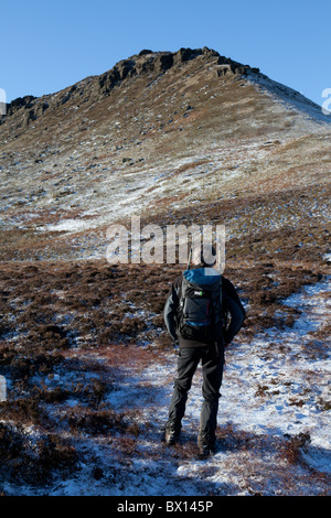 A male walker by Fairbrook in winter on Kinder Scout in the Dark Peak ...