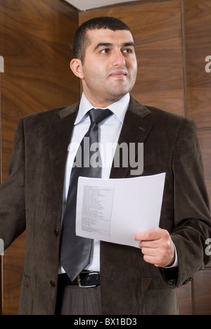 30 years old Middle Eastern businessman holding a paper inside office Beirut Lebanon Middle East Stock Photo