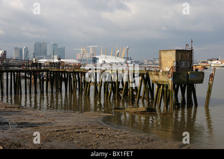 A jetty on the River Thames with London City, Canary Wharf and the O2 Millenium Dome behind. Stock Photo