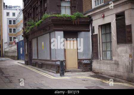 Boarded up shop restaurant in St James Stock Photo