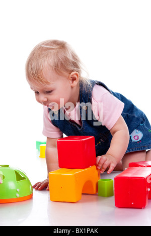 Beautiful baby building a castle with cubes isolated on white Stock Photo