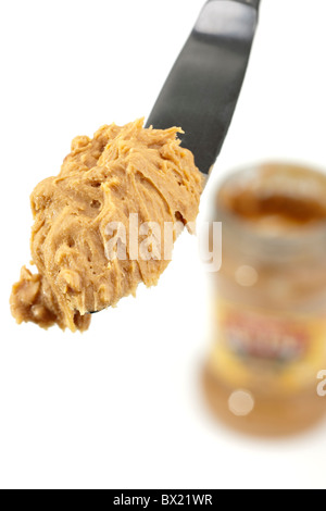 Jar and knife with creamy peanut butter on white background Stock Photo by  ©NewAfrica 193150800