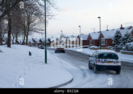 Cars braving the cold snow and ice to commute to work Stock Photo