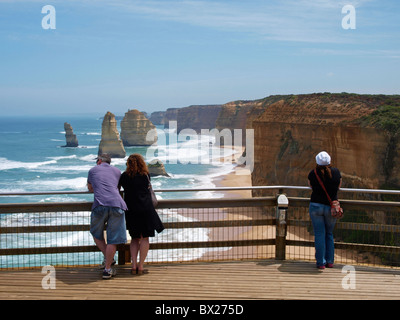 TOURISTS STAND AND ADMIRE TWELVE APOSTLES FROM VIEWING PLATFORM ON GREAT OCEAN ROAD, PORT CAMPBELL,  VICTORIA AUSTRALIA Stock Photo