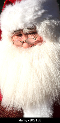 Portrait of Santa Claus with white beard and in red costume posing at ...