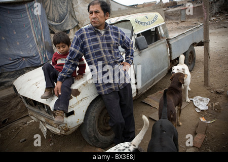 Man and his child with a truck outside their house. Villa el Salvador, Lima, Peru. Stock Photo