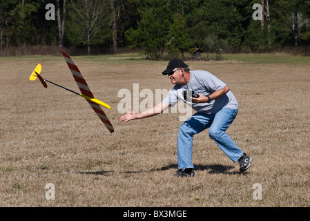 man catches his radio controlled hand launch glider in flight during competition, Alachua, Florida Stock Photo
