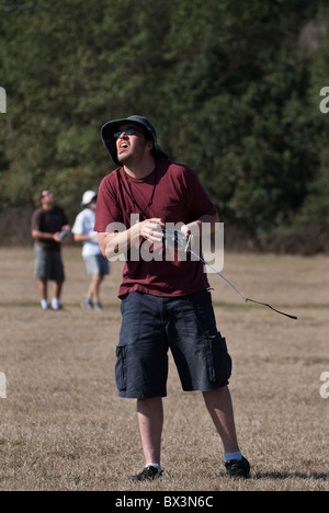 man uses radio control device to fly his hand launch glider during competition, Alachua, Florida. Stock Photo