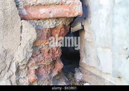 Cat peeking through hole Stock Photo