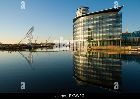 Quay House and the new footbridge (2010) over the Manchester Ship Canal at MediaCityUK, Salford Quays, Manchester, England, UK Stock Photo
