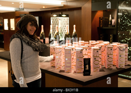 Teenage girl posing by a display of Moet and Chandon pink Champagne, the Moet and Chandon House, Epernay, France Stock Photo
