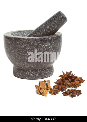 Granite mortar and pestle with winter spices of Cinnamon, cloves and Star Anise Stock Photo