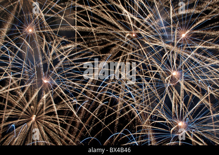 multiple firework explosions blue gold star radial Stock Photo