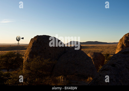 Old water pump windmill amidst the monolithic rock formations at the City of Rocks State Park in New Mexico, USA. Stock Photo