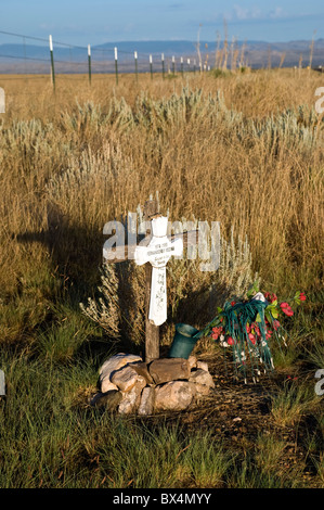 A roadside marker indicates where a loved one lost their life. Stock Photo