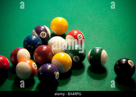 Colorful modern-style pool balls on a pool table already broken apart, waiting for the next player. Stock Photo