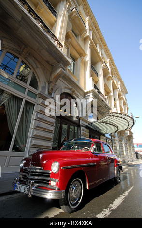 ISTANBUL, TURKEY. The renovated Pera Palas Hotel in Beyoglu district, with the hotel's classic Plymouth parked outside. 2010. Stock Photo