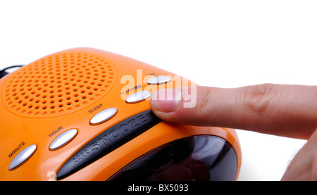 Finger pressing a snooze alarm button Stock Photo