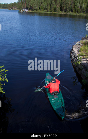 Man paddling with Wilderness Systems Ride 135 sit-on-top kayak , Finland Stock Photo
