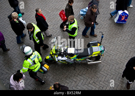 Paramedic motorcyclist, attending incident in pedestrian area of Bullring shopping centre, Birmingham UK Stock Photo