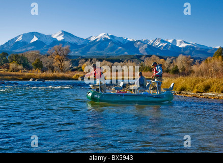 Married couple and professional guide fly fishing from a boat on the Arkansas River, near Salida, Colorado, USA Stock Photo