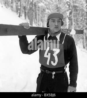 Czechoslovakia, Spindleruv Mlyn 1947. Ski jumper walks uphil with his skis before jump. CTK Vintage Photo Stock Photo