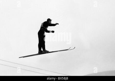 Czechoslovakia, Spindleruv Mlyn 1947. Ski jumper balancing in the air in funny pose during his jump. CTK Vintage Photo Stock Photo