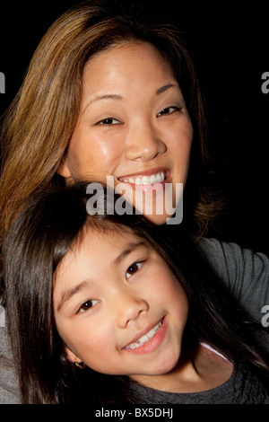 Portrait of happy japanese mother hugging with her cute little daughter