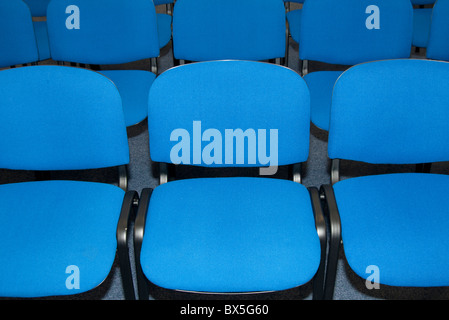rows of blue seats in a conference centre Stock Photo