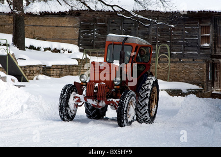 Tractor in Architectural Reserve Zheravna in winter snow Stock Photo