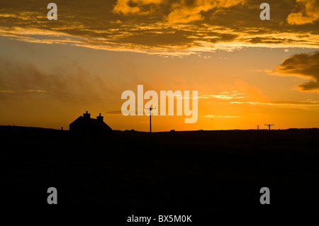 dh  ORPHIR ORKNEY Croft cottage orange sky cloud sunrise Stock Photo