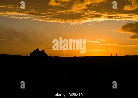 dh  ORPHIR ORKNEY Croft cottage orange sky cloud sunrise Stock Photo