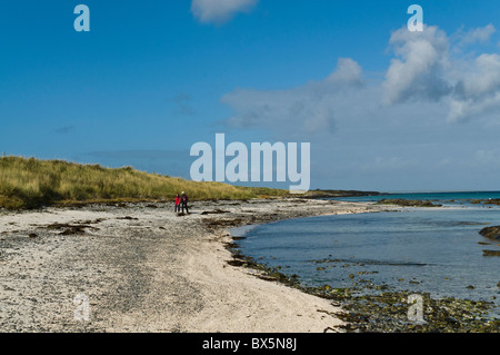 dh  EGILSAY ORKNEY Two tourist visitor hikers Egilsay sandy beach walking uk remote gb northern isles couple