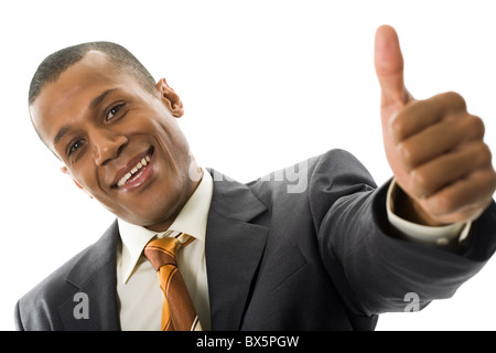 Happy businessman showing his thumb up with smile over white background Stock Photo