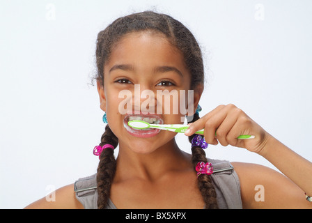 Portrait of a girl brushing her teeth Stock Photo