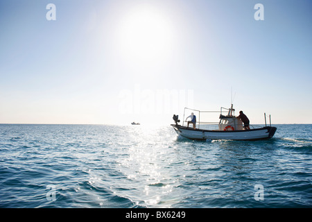 Fishermen on fishing boat at sea
