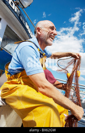 Fisherman holding fishing nets Stock Photo