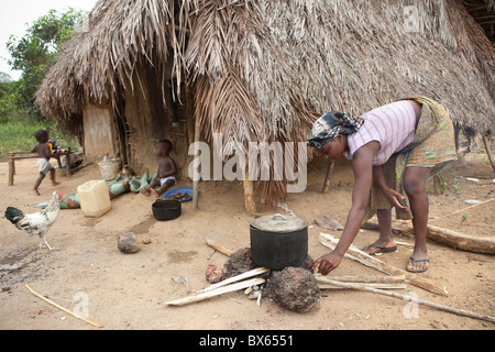 A woman cooks using firewood in Kakata, Liberia, West Africa. Stock Photo