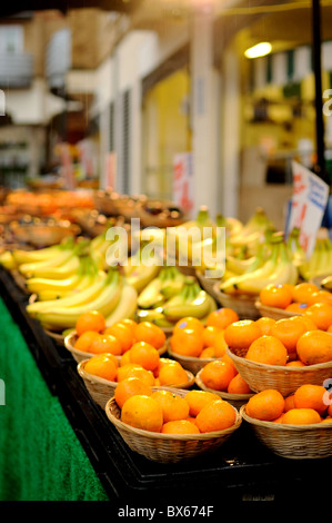 Fruit for sale on market stall light by halogen lights. Bright and vibrant colours where the fruit is slightly wet. Stock Photo