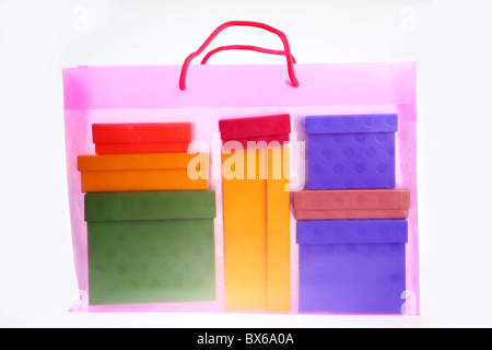 Colorful, transparent, plastic gift bags, filled with cardboard boxes. Stock Photo