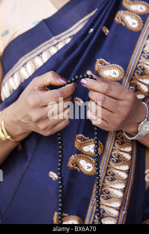Sri Lankan woman with Buddhist prayer beads, Paris, France, Europe Stock Photo