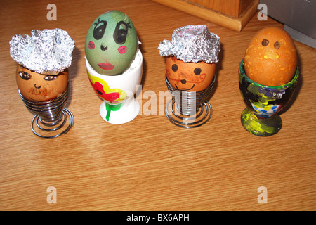Painted decorated hard boiled easter eggs in cups Stock Photo