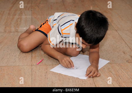 An Handsome Indian boy doing his artwork Stock Photo