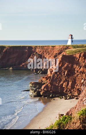 Lighthouse on a cliff overlooking a sandy beach on Havre-Aubert Island in the Iles de la Madeleine, Quebec, Canada Stock Photo